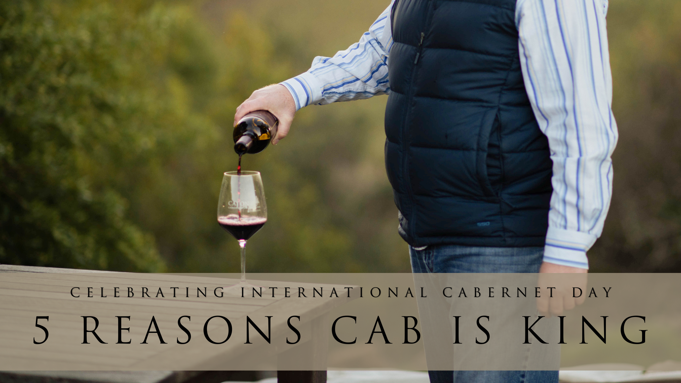 alt= Person pouring red Sonoma Valley wine into a glass on a wooden table, with text "celebrating international cabernet day - 5 reasons cab is king.